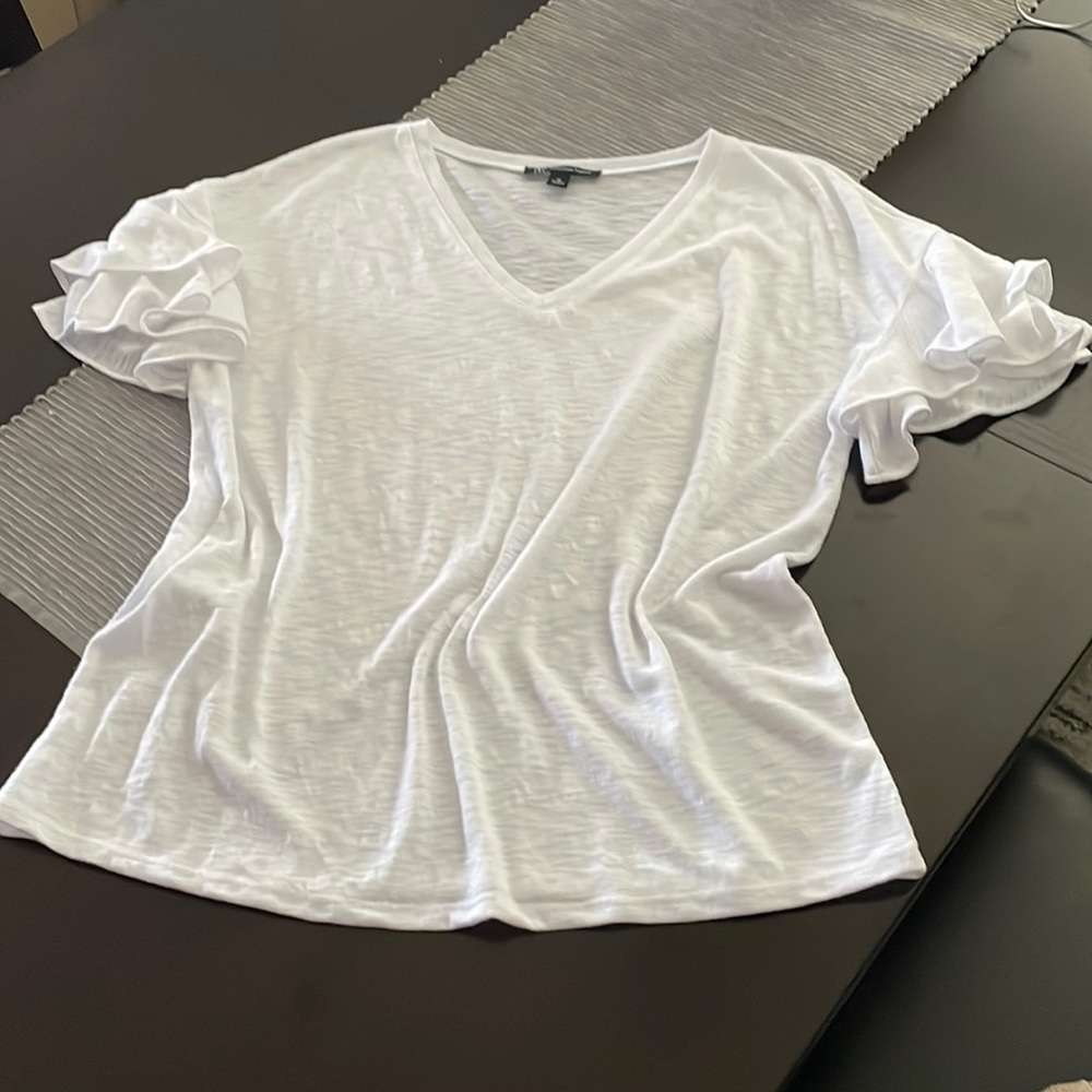 Cruise wear T Shirt by INC. White with Fluffy ruffle sleeves. Like new.